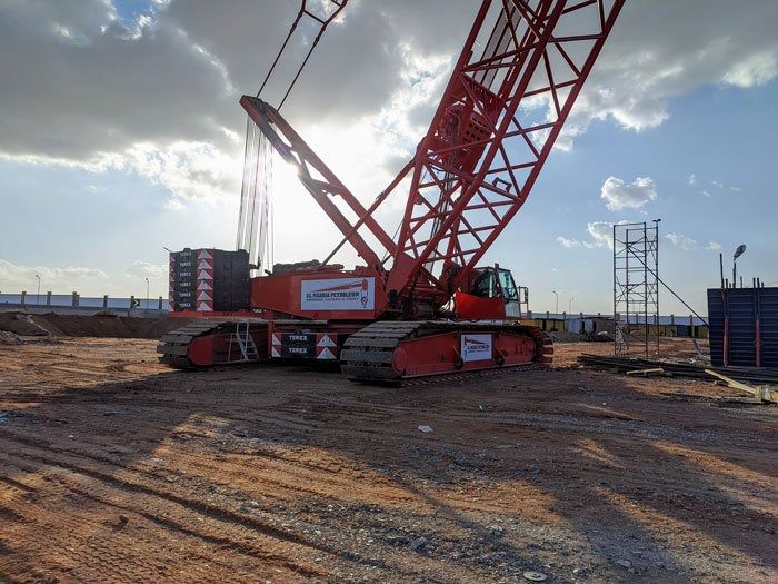 Red Terex crawler crane at a construction site